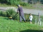 Helping Grandpa cut the grass
